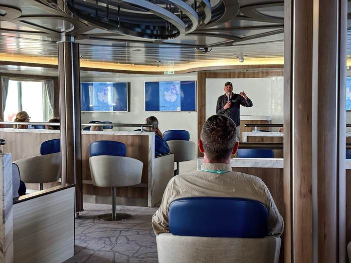 AE Expeditions, Guest watching a lecture, Greg Mortimer, David Stock @ Divergent Travelers.jpg